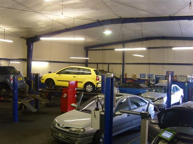 inside the garage with yellow and silver car
