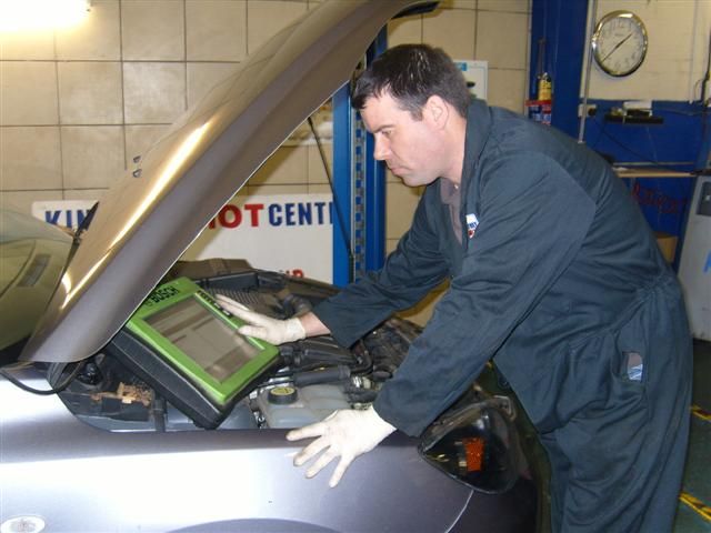 man using diagnostics on a car